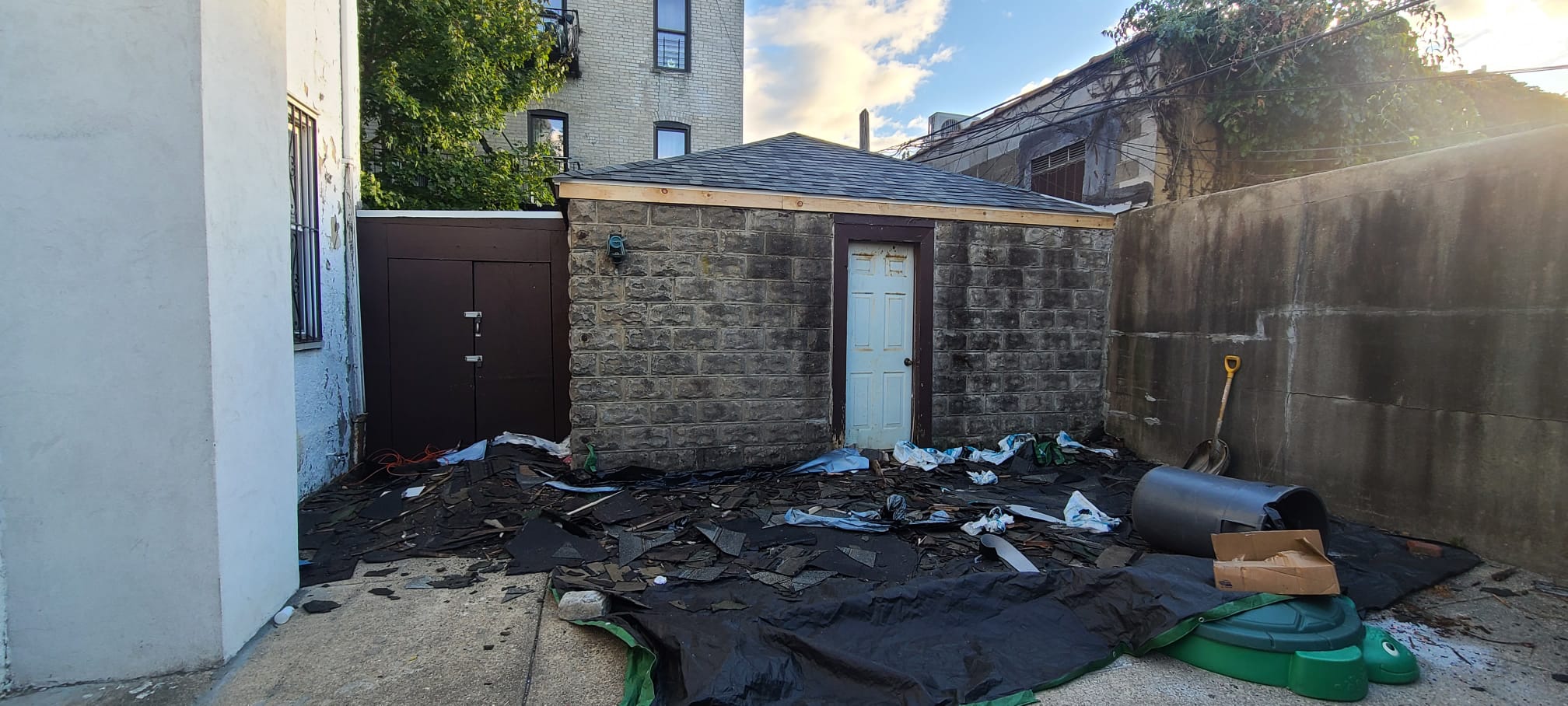 Various roofing materials displayed - shingles, metal, TPO, slate