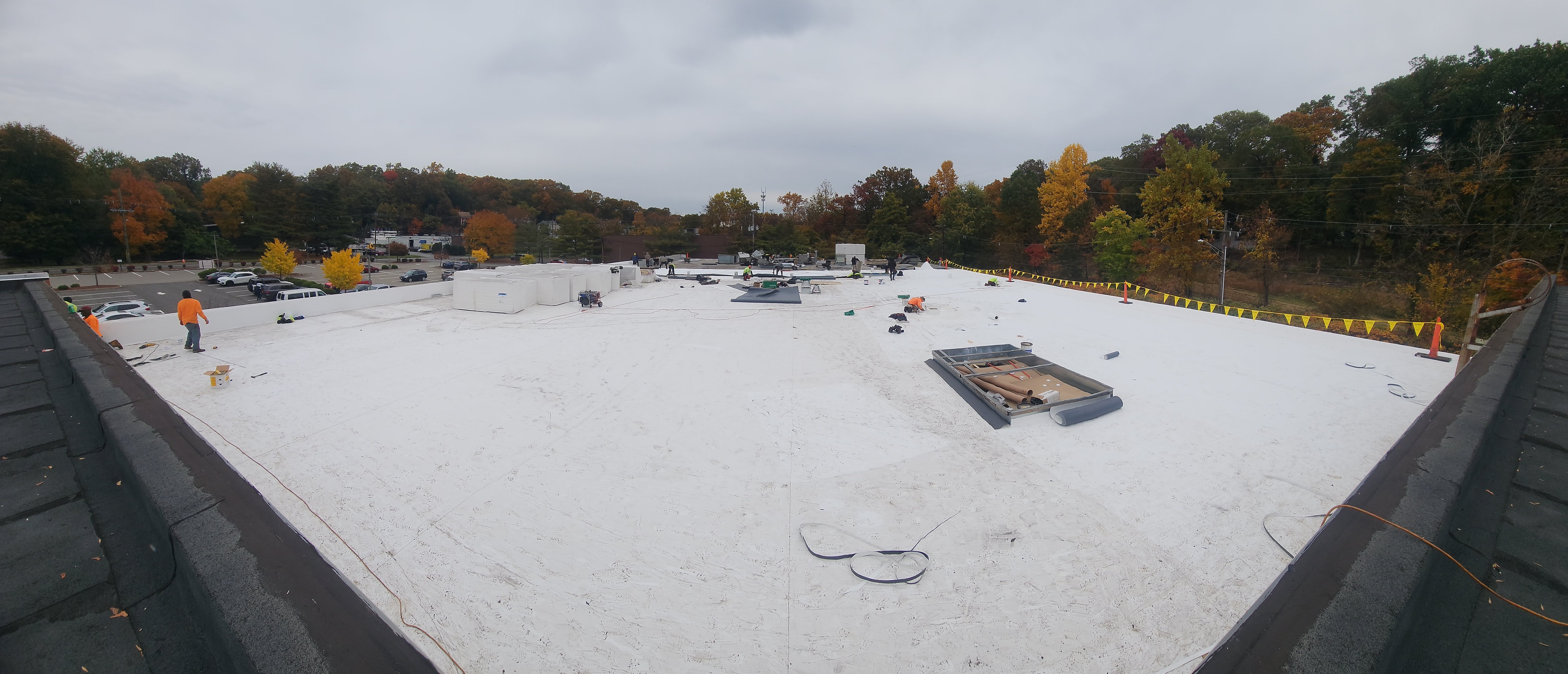 Professional roof maintenance in NYC showing inspector on Brooklyn brownstone